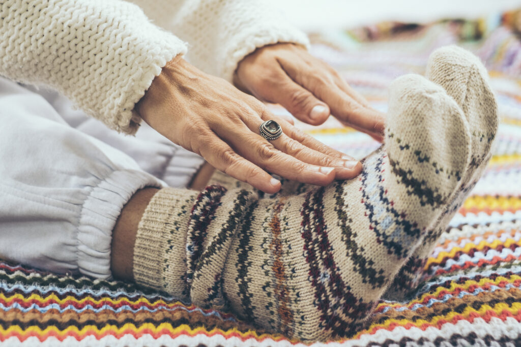 – International Students House – international students house close up of woman on the bed wearing wool socks