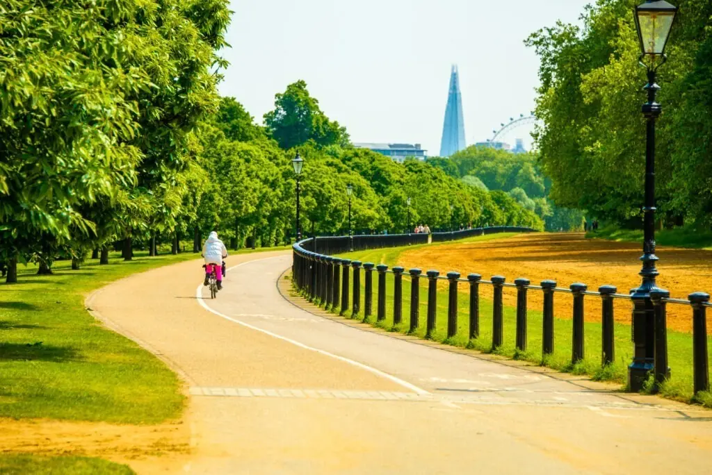 A beautiful path in Hyde Park in London with the Shard skyscraper on the horizon