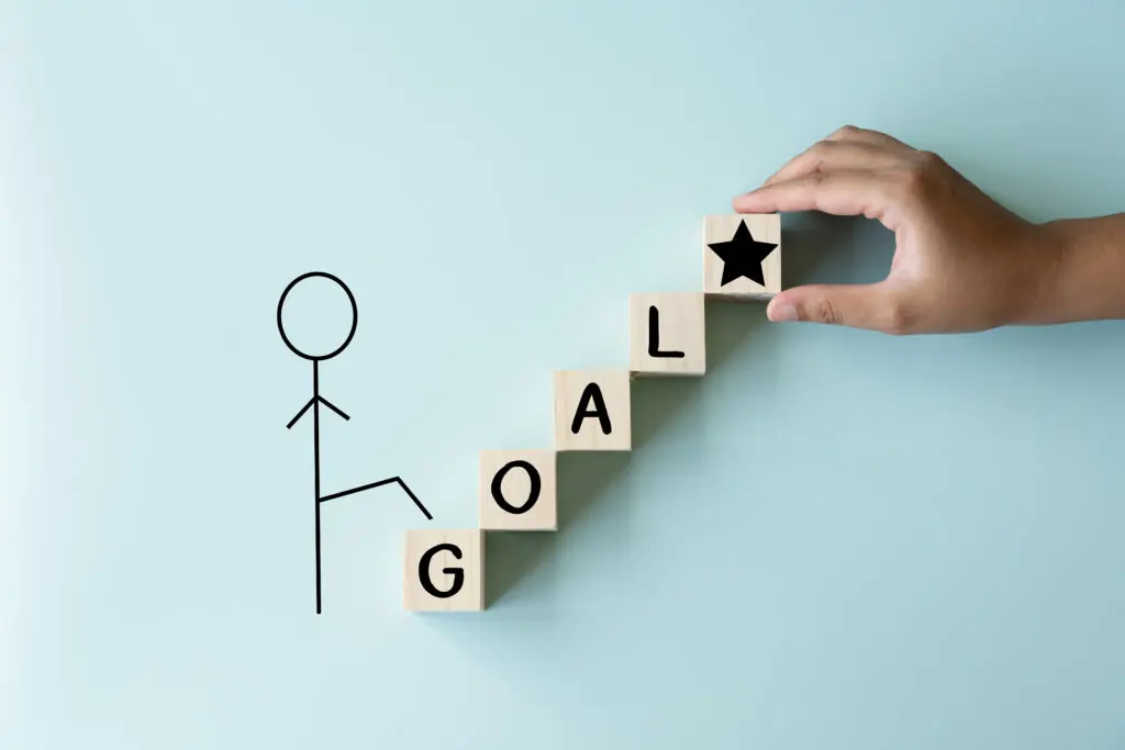 A man climbing to his goal of achievement, wooden blocks as stairs to the star the top prize of life. Target of one person on process.