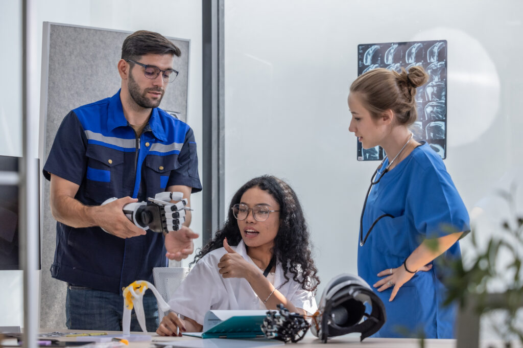 Robotic rehabilitation engineer work with an orthopedic doctor and a surgeon to create somatosensory robotic arms and hands for patients requiring advanced prosthetics or rehabilitation support.
