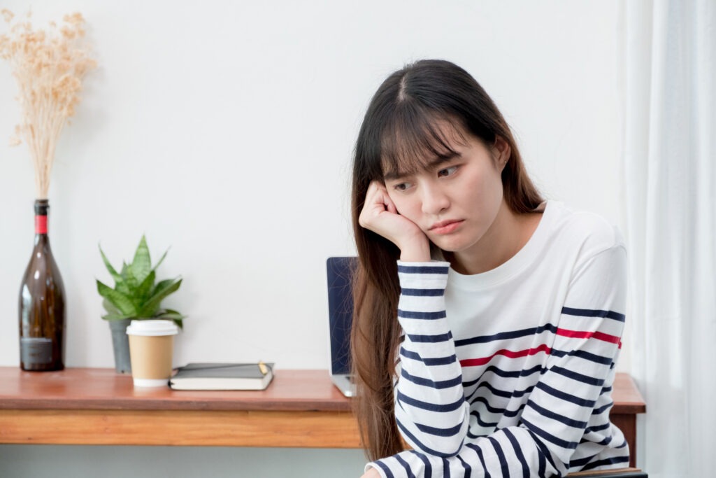 A woman sitting alone and looking sad