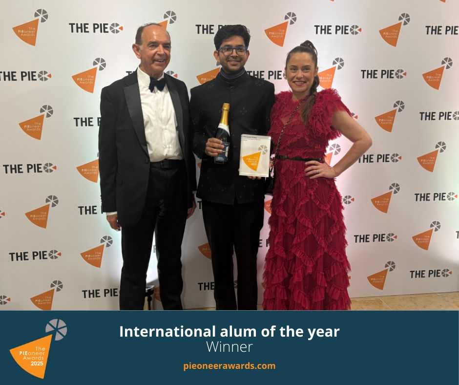 Three people posing for a photograph at an awards ceremony
