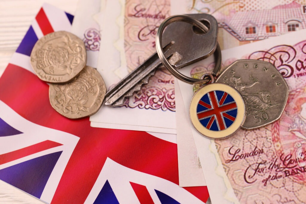 British bank notes, UK flag and key chain with 2 20ps and a 50p with a home key
