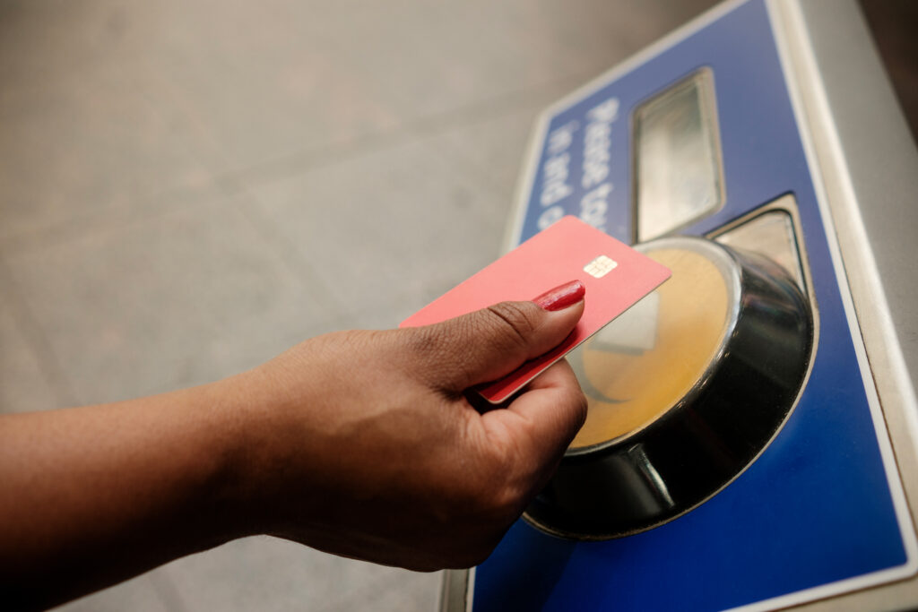 A close up of a woman taping her card at the station