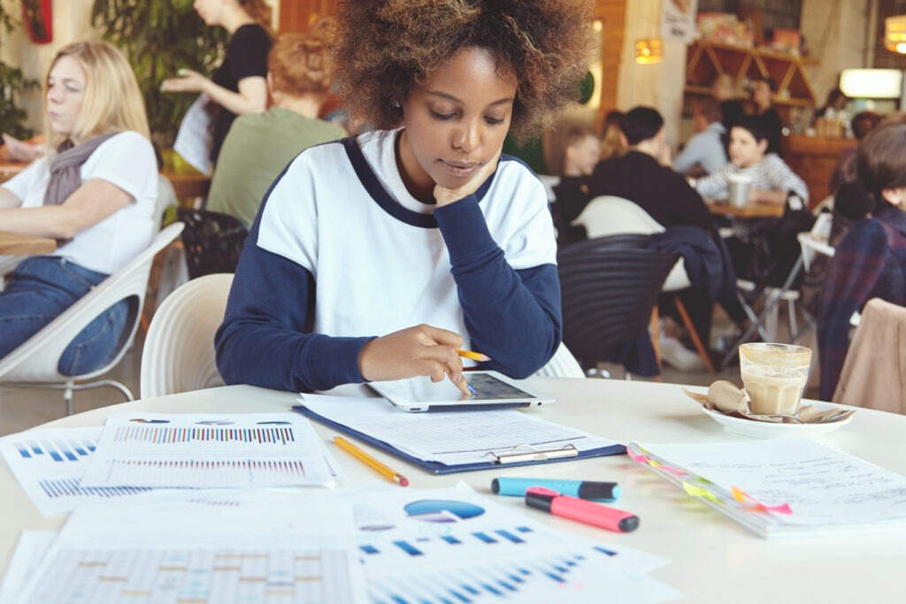 A young woman budgeting on an iPad 