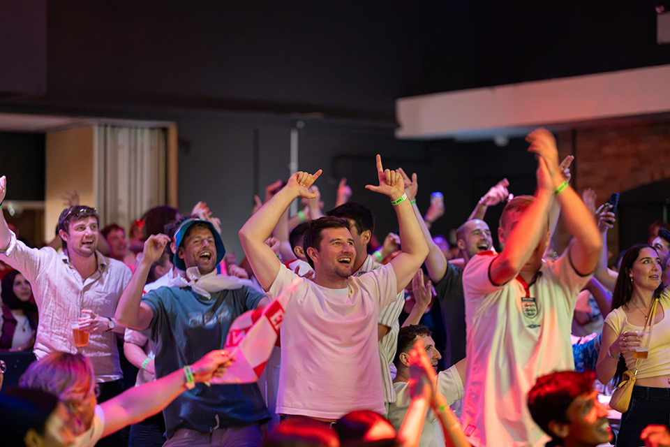 – international students house football watch party in 229 london, england vs argentina, fans cheering for england