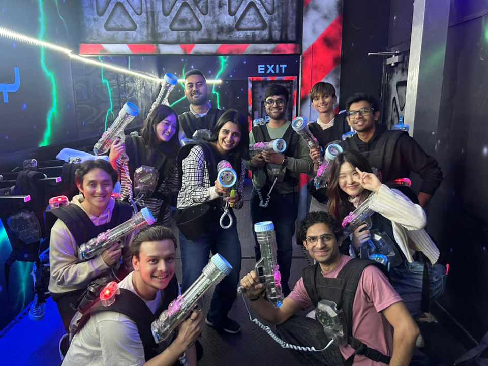 – international students house a group of students holding lasertags